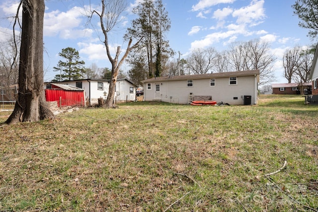 rear view of property featuring brick siding and a lawn