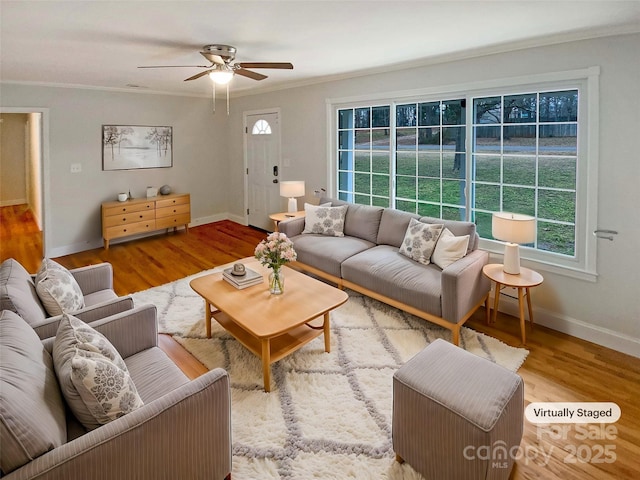 living room with ornamental molding, hardwood / wood-style floors, and ceiling fan