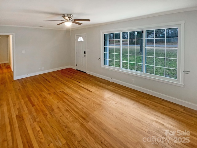 interior space with crown molding, ceiling fan, plenty of natural light, and hardwood / wood-style flooring