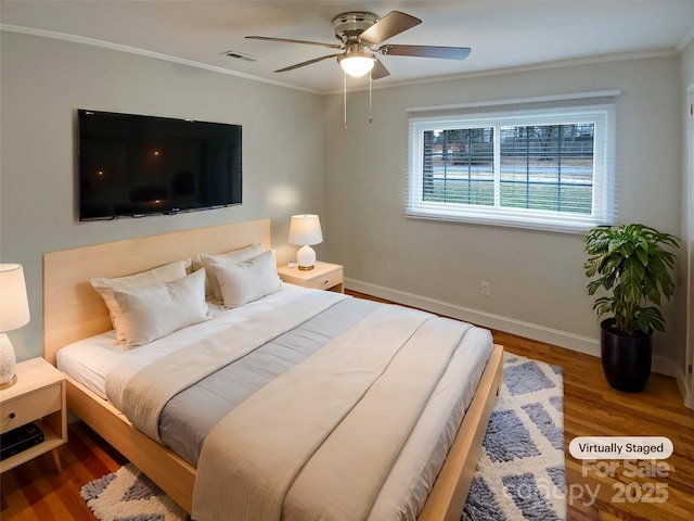 bedroom with wood-type flooring, ornamental molding, and ceiling fan