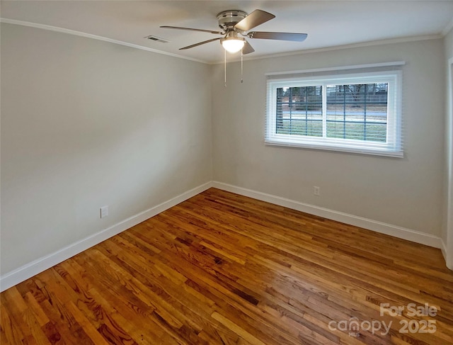 empty room with crown molding, hardwood / wood-style floors, and ceiling fan