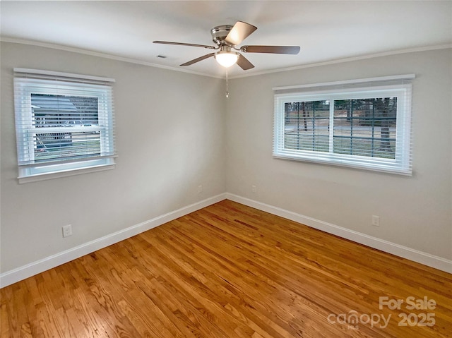 spare room with crown molding, wood-type flooring, and ceiling fan