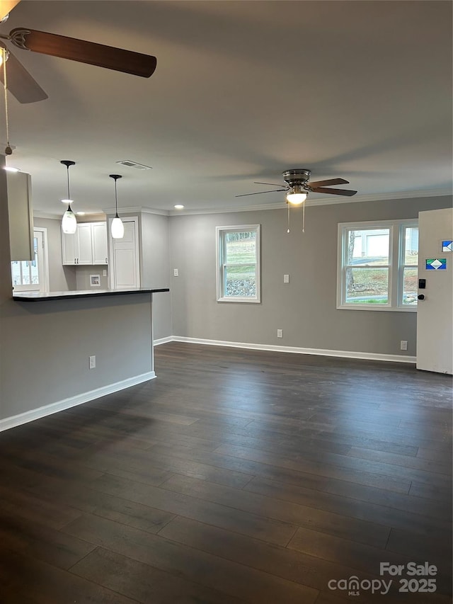 unfurnished living room with visible vents, dark wood finished floors, baseboards, and ceiling fan