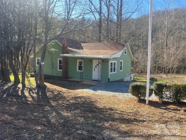 view of front of property with covered porch and a shingled roof