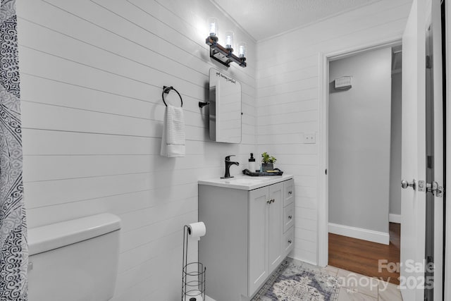 bathroom with vanity, hardwood / wood-style floors, a textured ceiling, and toilet