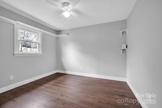 empty room featuring ceiling fan, a textured ceiling, and dark hardwood / wood-style flooring