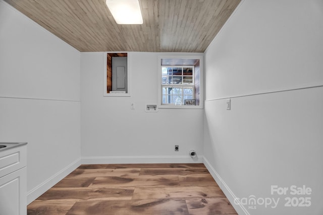 washroom featuring hardwood / wood-style floors, washer hookup, electric panel, hookup for an electric dryer, and wooden ceiling