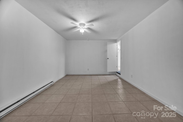 tiled empty room with ceiling fan and baseboard heating