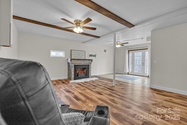 living room with hardwood / wood-style floors, beam ceiling, and ceiling fan