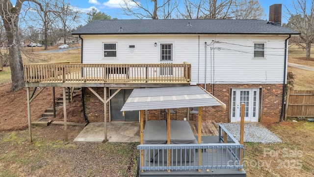 back of house with french doors, a deck, and a patio area