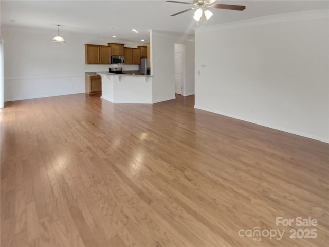 unfurnished living room with crown molding, ceiling fan, and light hardwood / wood-style flooring