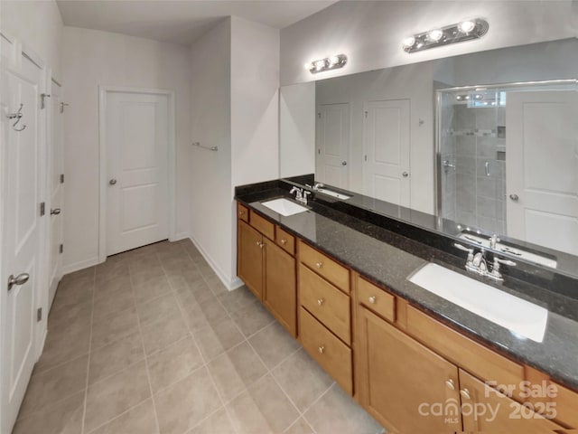 bathroom featuring vanity, a shower with shower door, and tile patterned flooring