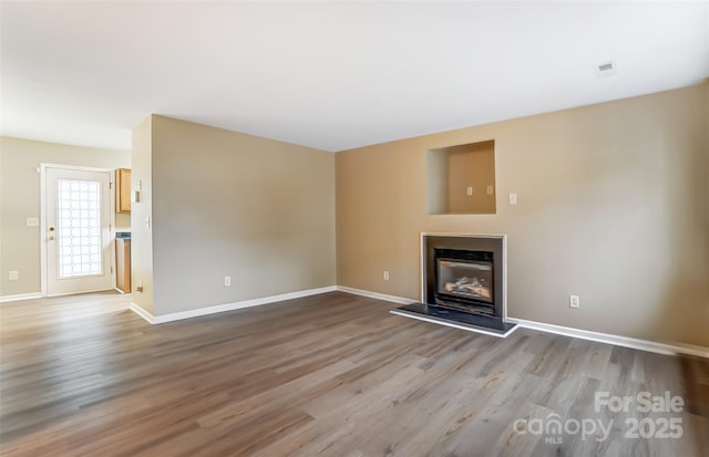 unfurnished living room featuring light hardwood / wood-style flooring