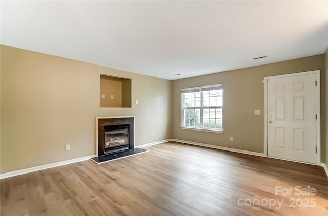 unfurnished living room featuring light hardwood / wood-style flooring