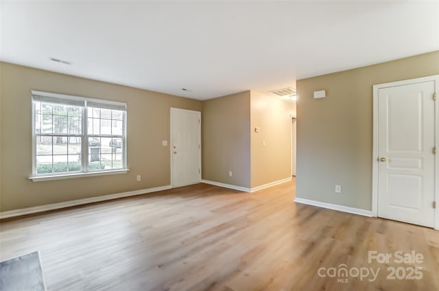 empty room with light hardwood / wood-style flooring