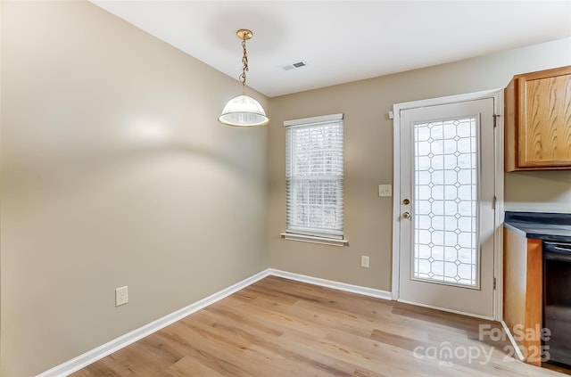 entryway featuring vaulted ceiling and light hardwood / wood-style flooring