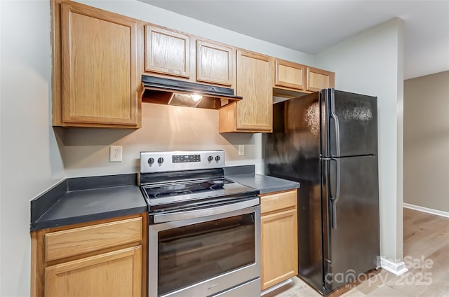 kitchen featuring black fridge, light wood-type flooring, light brown cabinetry, and stainless steel range with electric stovetop