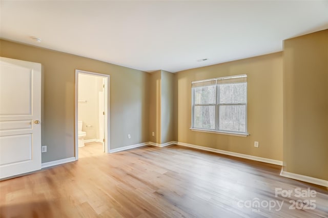 empty room with light hardwood / wood-style flooring