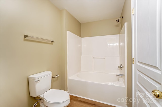 bathroom with shower / tub combination, wood-type flooring, and toilet