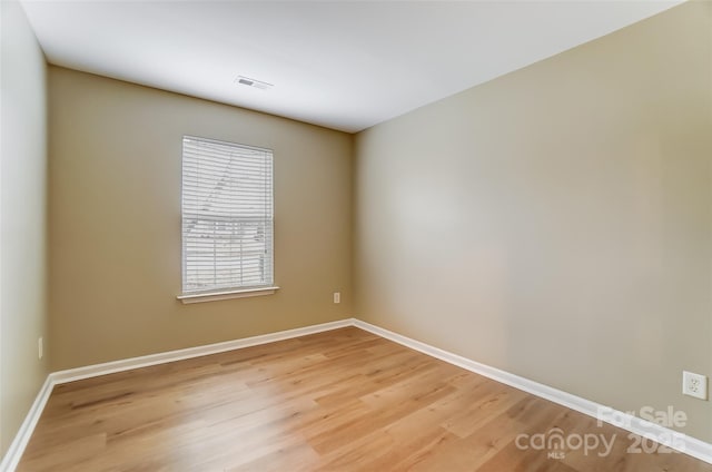 unfurnished room with hardwood / wood-style flooring