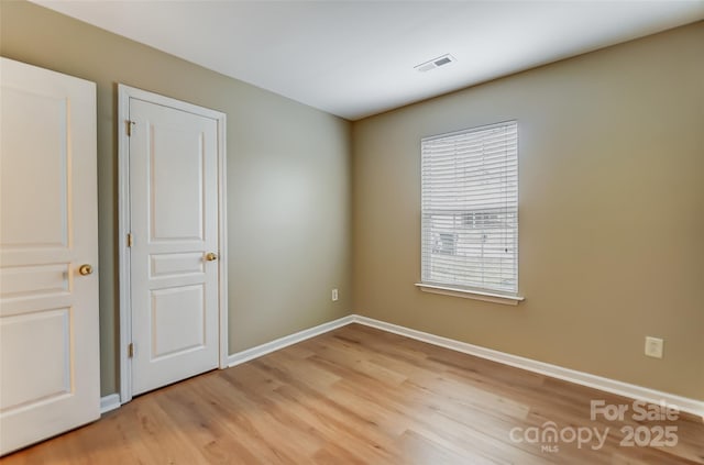 unfurnished room featuring light hardwood / wood-style floors