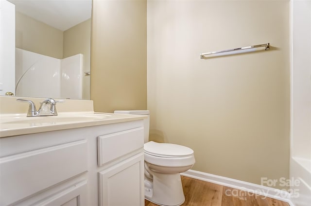 full bathroom featuring hardwood / wood-style flooring, vanity, toilet, and plus walk in shower