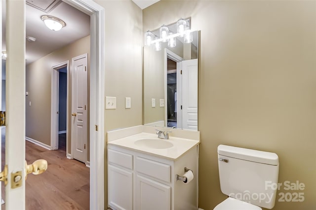 bathroom featuring hardwood / wood-style flooring, vanity, and toilet