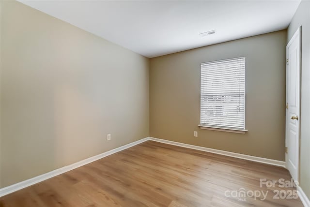 spare room with light hardwood / wood-style flooring