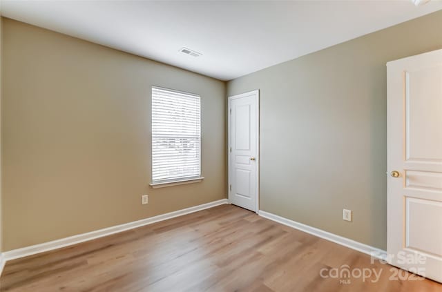 empty room with light hardwood / wood-style floors