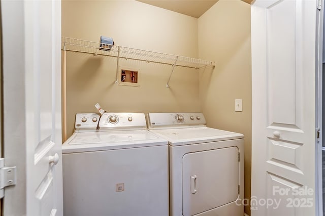 clothes washing area featuring separate washer and dryer