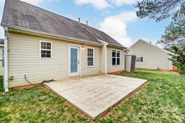 rear view of house with a yard and a patio area