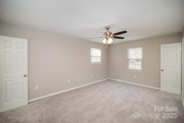 carpeted empty room with ceiling fan