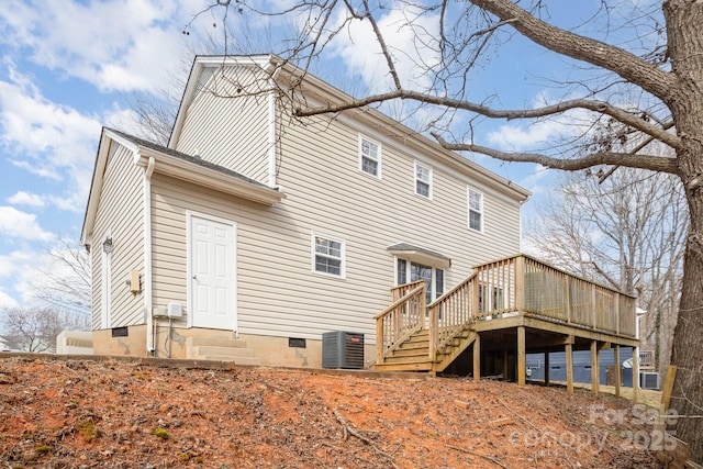 back of property with a deck and central air condition unit