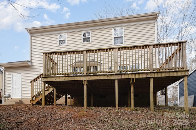 rear view of house with a wooden deck