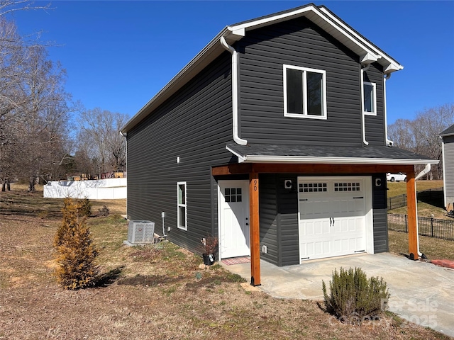 exterior space with a garage and central air condition unit