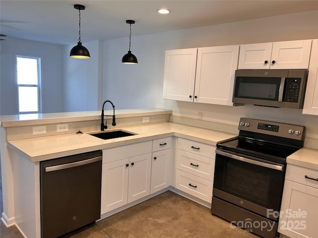 kitchen featuring stainless steel appliances, white cabinetry, hanging light fixtures, and sink