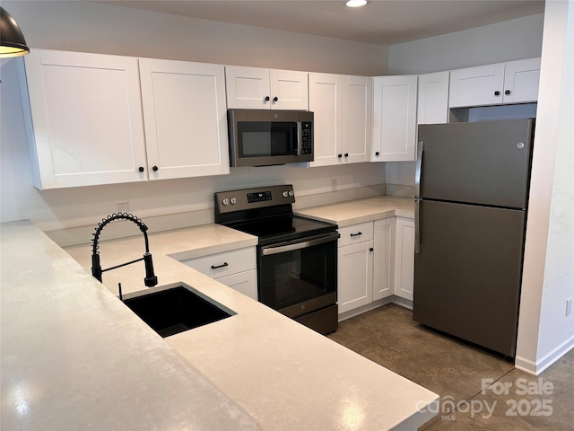 kitchen with stainless steel appliances, sink, and white cabinets