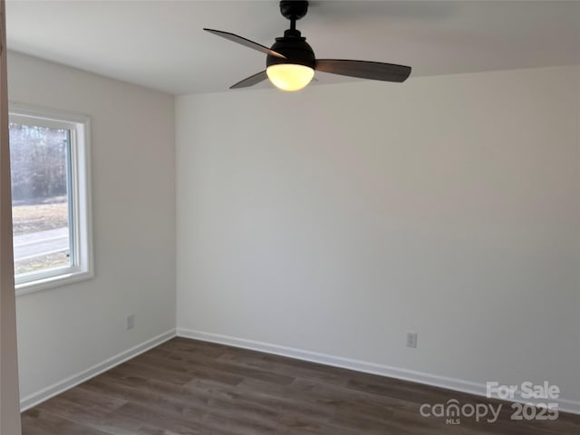 unfurnished room with plenty of natural light, dark hardwood / wood-style floors, and ceiling fan