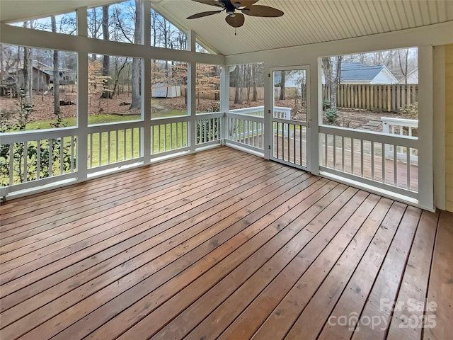 unfurnished sunroom with plenty of natural light, lofted ceiling, and ceiling fan