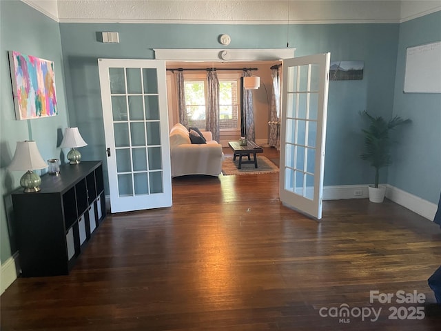 interior space with crown molding, french doors, and dark wood-type flooring