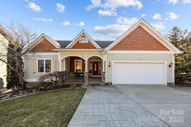 craftsman-style house featuring a porch, a garage, and a front lawn