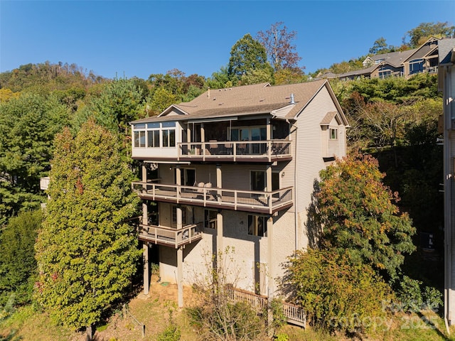 rear view of property with a sunroom