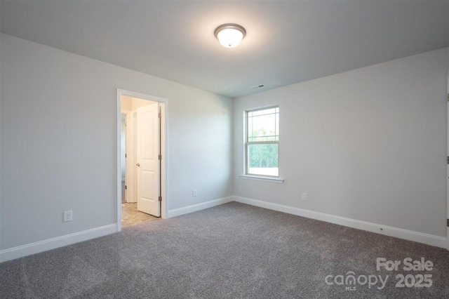 empty room featuring light colored carpet