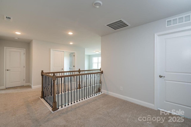 corridor with light colored carpet