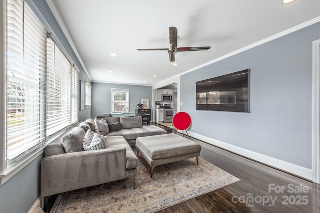 living room with crown molding, dark wood-type flooring, and ceiling fan