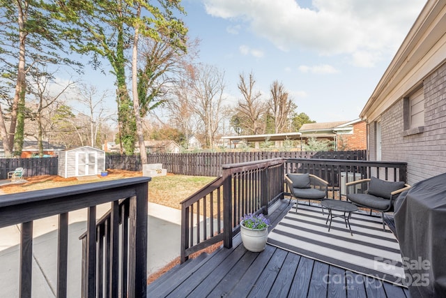 wooden deck with grilling area and a storage shed