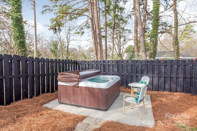 view of patio / terrace with a hot tub