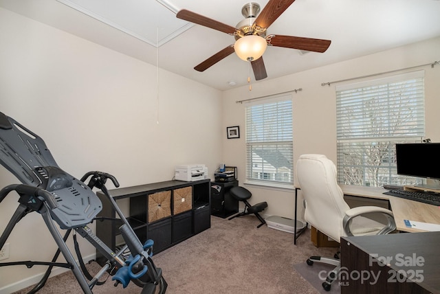 home office with a ceiling fan, light colored carpet, and attic access