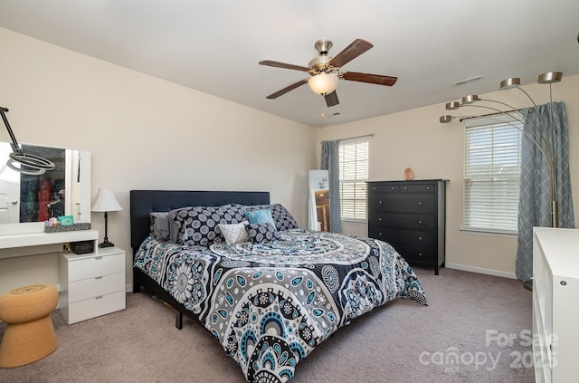 bedroom with light carpet, baseboards, a ceiling fan, and visible vents