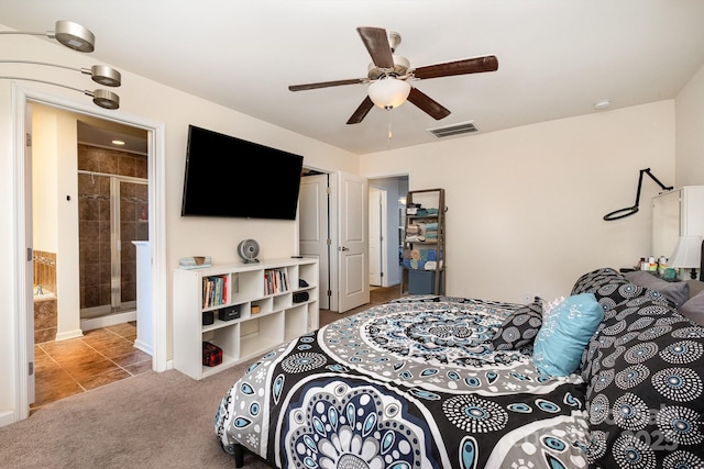 bedroom featuring light carpet, a ceiling fan, ensuite bath, and visible vents